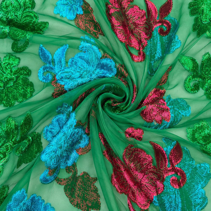 Grön lurexchiffong med färggrika blomstermotiv – tyget format som en spiral (bild 1 av 3)