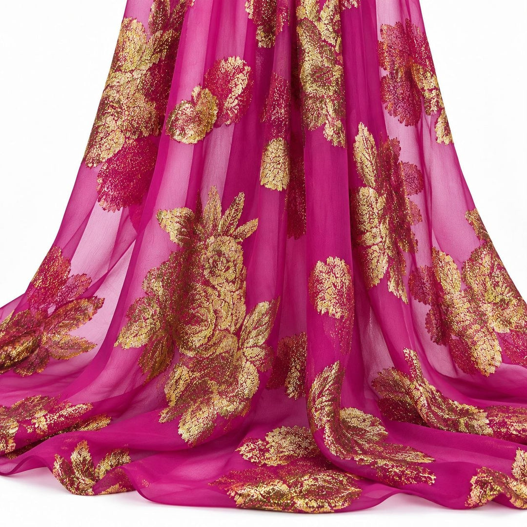 Magenta lurex chiffonsilk med stora gyllene blomstermotiv – hängande i mjuka veck på vit bakgrund (bild 2 av 3)