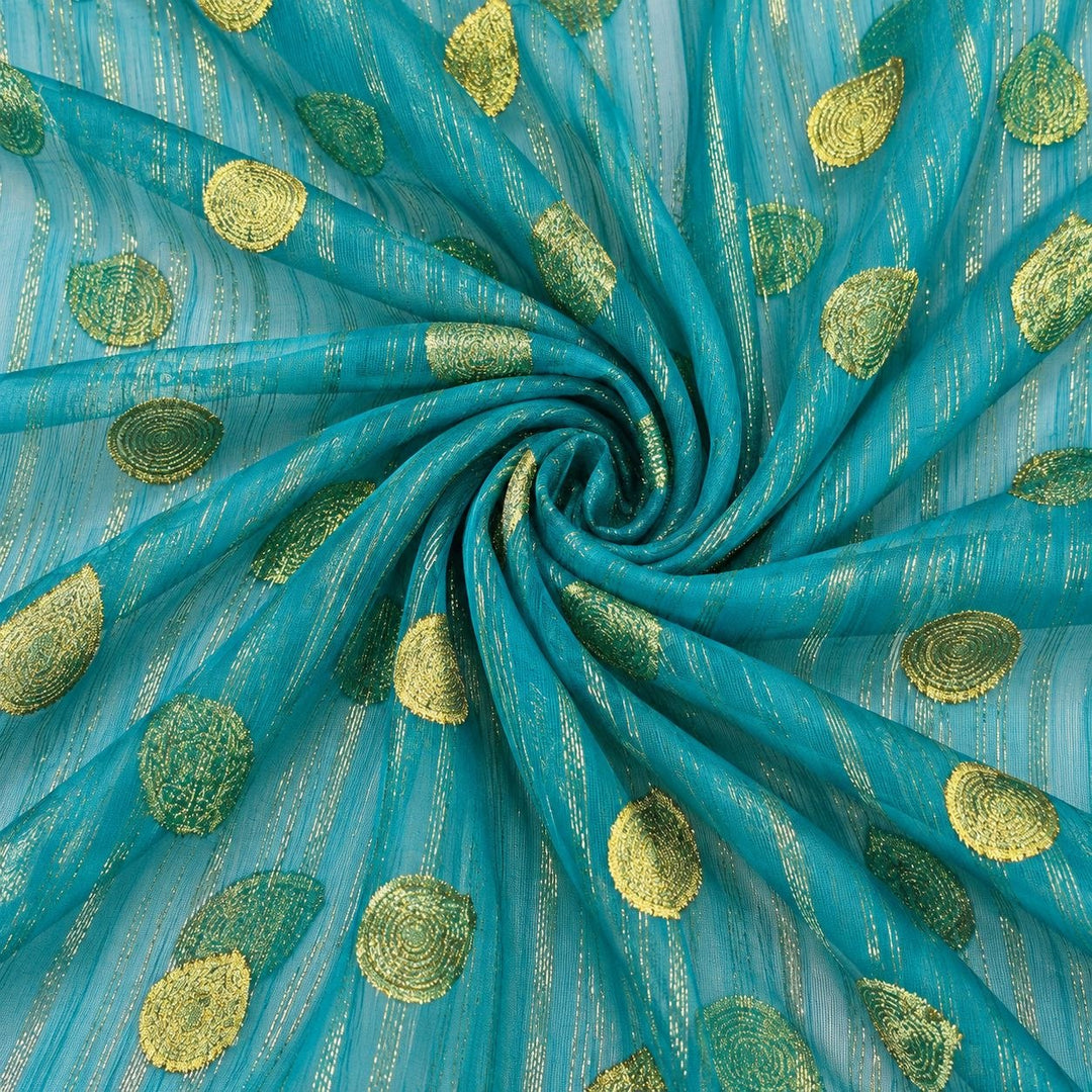 Turkos lurex chiffonsilk med gyllene ränder och motiv – tyget format som en spiral (bild 1 av 3)