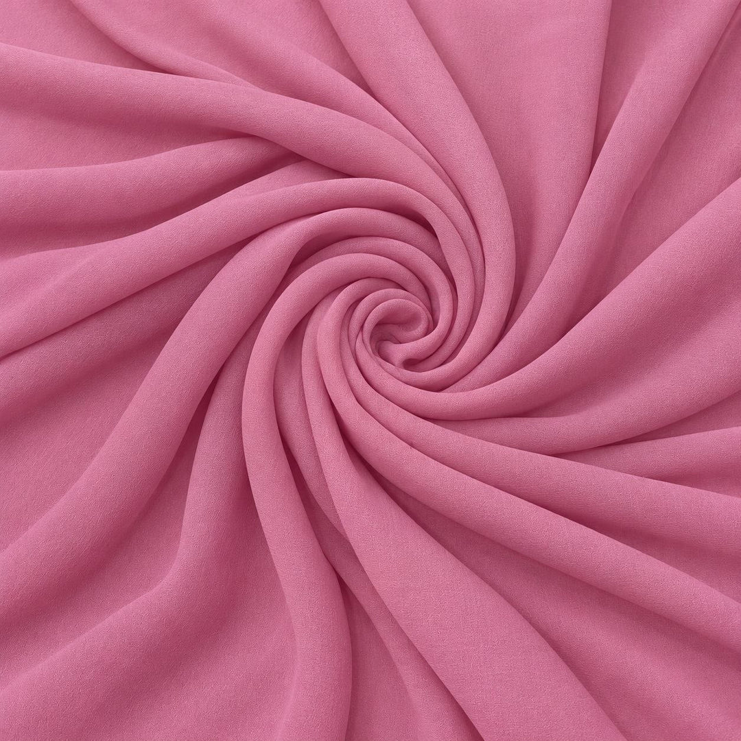 Rosa sidengeorgette – tyget format som en spiral, där den creppade ytan syns (bild 1 av 3)