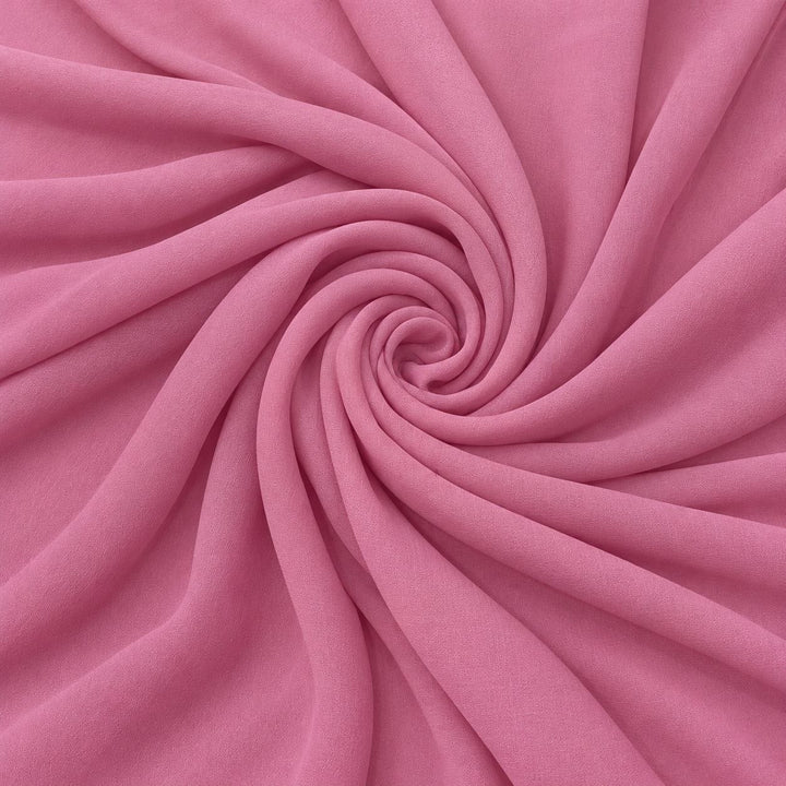 Rosa sidengeorgette – tyget format som en spiral, där den creppade ytan syns (bild 1 av 3)