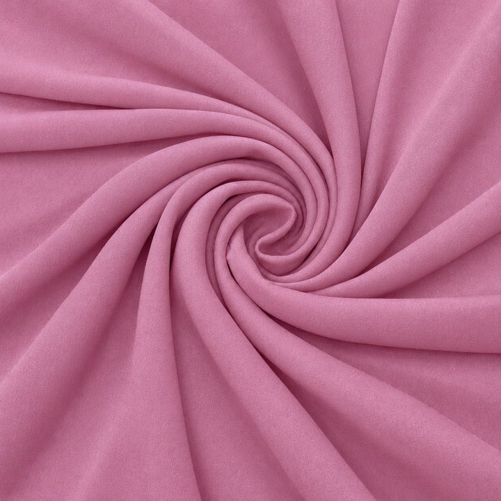 Dammigt rosa sidengeorgette – tyget format som en spiral, där den creppade ytan syns (bild 1 av 3)