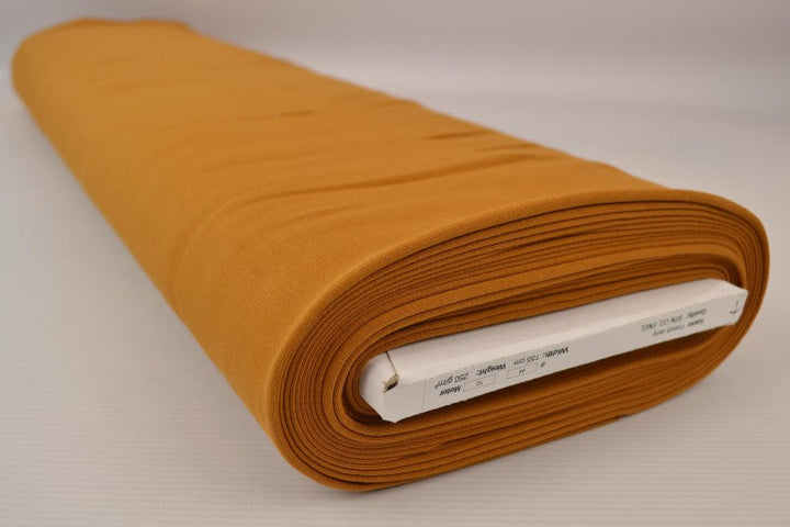 MÖRK OCKRAGUL FRENCH TERRY – MJUK BOMULLSSTICKAD METERVARA MED STRETCH